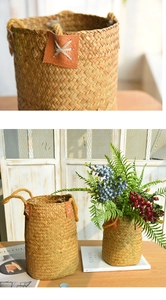 Close-up of handwoven seagrass flower basket with leather tag and natural hemp handles