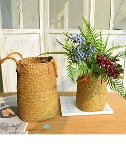 Close-up of handmade seagrass flower baskets with reinforced brown leather handles