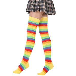 Close-up of rainbow striped over-knee high socks with vibrant knitted cotton texture