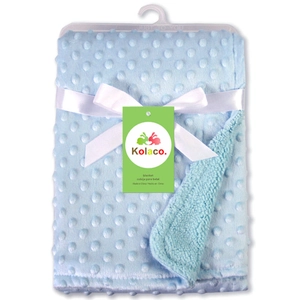 Soft light blue minky dot baby blanket with white ribbon and decorative brand tag