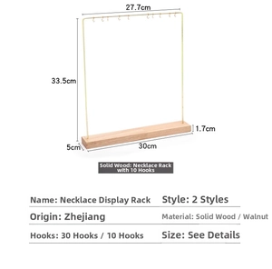 Detail of gold metal necklace rack with 10 hooks and a solid natural wood base