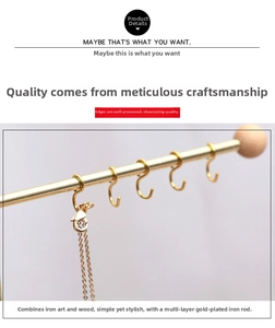Detail of gold-plated iron necklace rack with wooden ball tip and S-shaped hooks