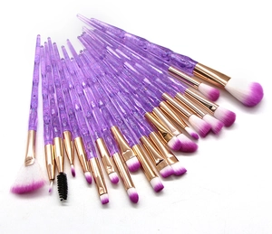 Detail view of 20-piece makeup brush set with purple glitter handles and golden ferrules