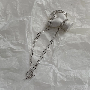 Close-up of silver OT toggle clasp necklace with hammered texture links on stone art