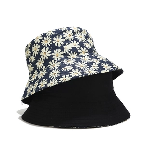 Reversible daisy print bucket hat for women in navy blue floral and solid black cotton