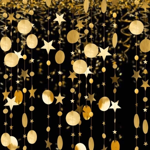 Detailed view of shimmering gold star and circle hanging decorations against a dark backdrop.