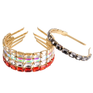 Close-up of four thin gold metal headbands with large rectangle crystals in multiple colors