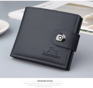 Detail of men's short leather wallet with litchi grain and buckled strap closure
