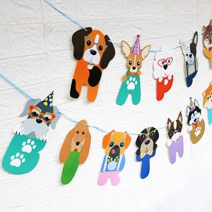 Detailed view of cartoon dog breed banner cards with Happy Birthday lettering on wall