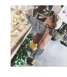 Detail of yellow cat shaped mini shoulder bag for girls made of soft synthetic PU leather