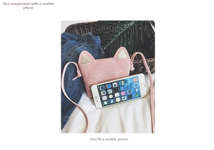 Pink mini cat crossbody bag showing size comparison and capacity for a smartphone