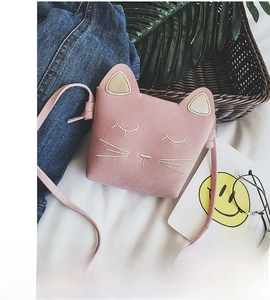 Detailed view of pink cat crossbody bag with cute embroidery in a stylish setting