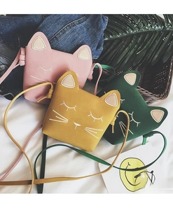 Detailed view of three mini cat-shaped crossbody bags in pink, yellow, and green matte PU leather