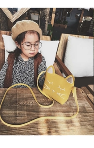 Detail of yellow cat-shaped toddler purse with white embroidery and fine PU leather strap