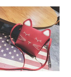 Detailed close-up of a red cat-shaped silicone shoulder bag with 3D ears and embroidery