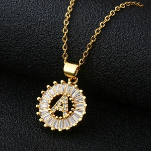 Golden necklace featuring a sunburst pendant with letter A and cubic zirconia stones
