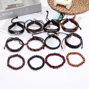 Set of 12 vintage braided leather bracelets with wooden beads and metallic charms