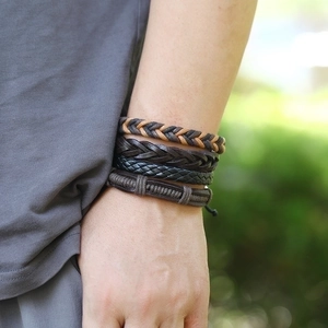 Set of four vintage braided leather bracelets for men in brown and black tones