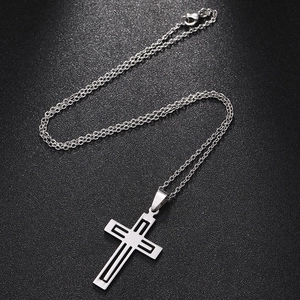 Close-up of silver stainless steel double-layered cross pendant with fine link chain