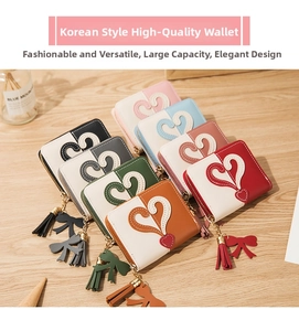Flat lay of multiple color-block zip wallets with heart patterns and tassel charms