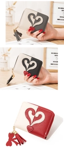 Close-up of heart patchwork design and tassel zipper on compact PU leather wallets