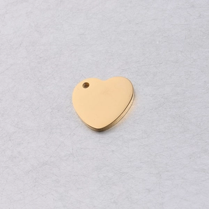 Detailed close-up of a 15mm gold-finished stainless steel heart pendant with a smooth mirror finish