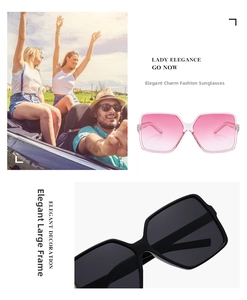 Detail view of oversized square sunglasses in pink gradient and classic black frames