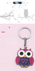 Detail view of the colorful pink and purple enamel cartoon owl keychain decoration