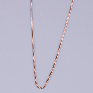 Detailed close-up of a rose gold titanium link chain necklace on a clean grey background