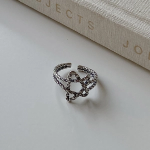Close-up of vintage 925 silver star ring with snake scale texture and oxidized finish
