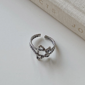 Macro shot of 925 silver star ring featuring vintage scale texture and open adjustable band
