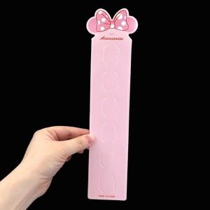 Pink jewelry display card featuring a polka dot bow and multiple accessory slots