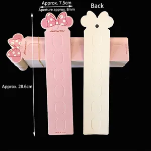 Pink and white long card for accessories with bow design and six slots, 28.6cm length