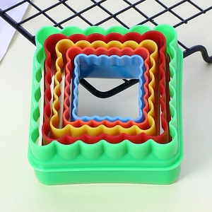 Macro shot of 5 nested colorful plastic square cookie cutters with fluted edges
