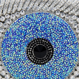 Macro shot of eye clutch bag featuring high-density blue and silver rhinestones detail