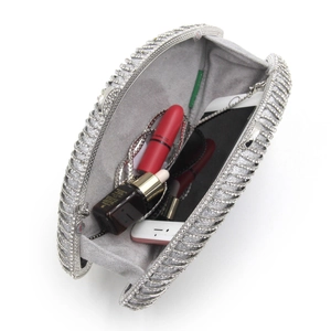 Silver rhinestone eye clutch bag interior view with chain strap and phone for scale