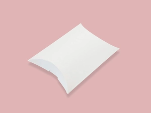 White paper pillow gift box for wedding favors shown on a soft pink background