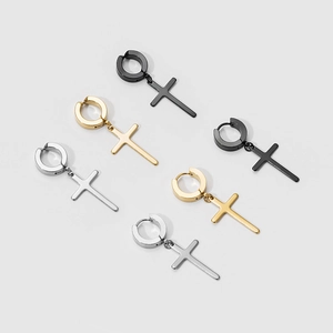 Detail of cross earrings in black, gold and silver finishes, clip-on and hoop styles