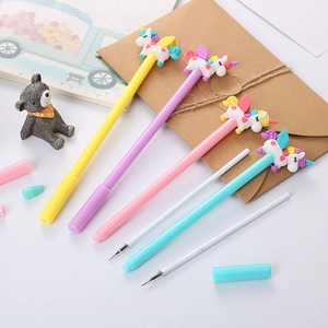 Cute cartoon unicorn gel pens in four pastel colors on a creative stationery desktop