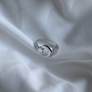 Detail of 925 sterling silver ring featuring hollow star and moon geometric patterns