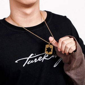 Men's gold shield pendant necklace featuring a black hexagram star and twisted chain