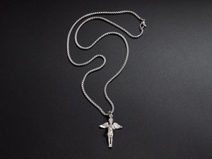 Macro shot of silver angel wing pendant on a round box chain over a dark backdrop
