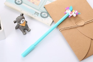 Close-up of a light blue cartoon unicorn gel pen with a 3D silicone topper for students