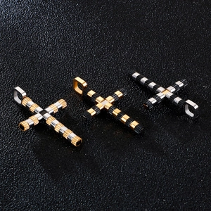 Classic stainless steel cross pendants in gold, black and silver on dark background