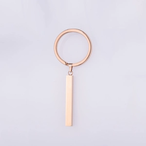 Macro detail of blank rose gold stainless steel bar pendant on a minimalist keychain ring