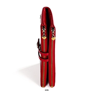Detail of red long wallet featuring double zippers and golden heart pendants