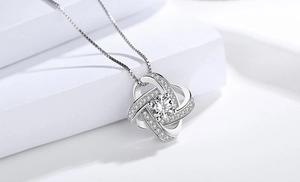 Macro shot of S925 sterling silver spinning clover necklace with sparkling diamonds