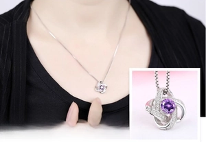 Detail of S925 sterling silver four-leaf clover necklace with dancing purple zircon stone