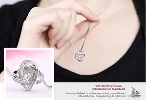 Detail of S925 sterling silver love knot necklace with sparkling zircon stone inlay
