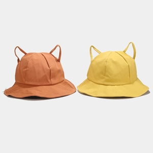 Detail of two kids bucket hats in orange and yellow with cute animal ear designs
